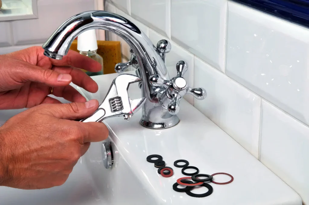 Plumber performing maintenance on a bathroom faucet in Orlando