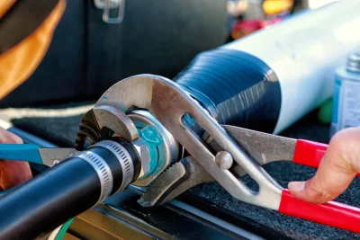 Technician tightening an industrial pipe connection in Orlando