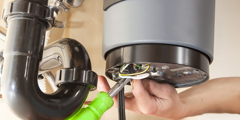 Technician repairing the heating element of a water heater in Orlando