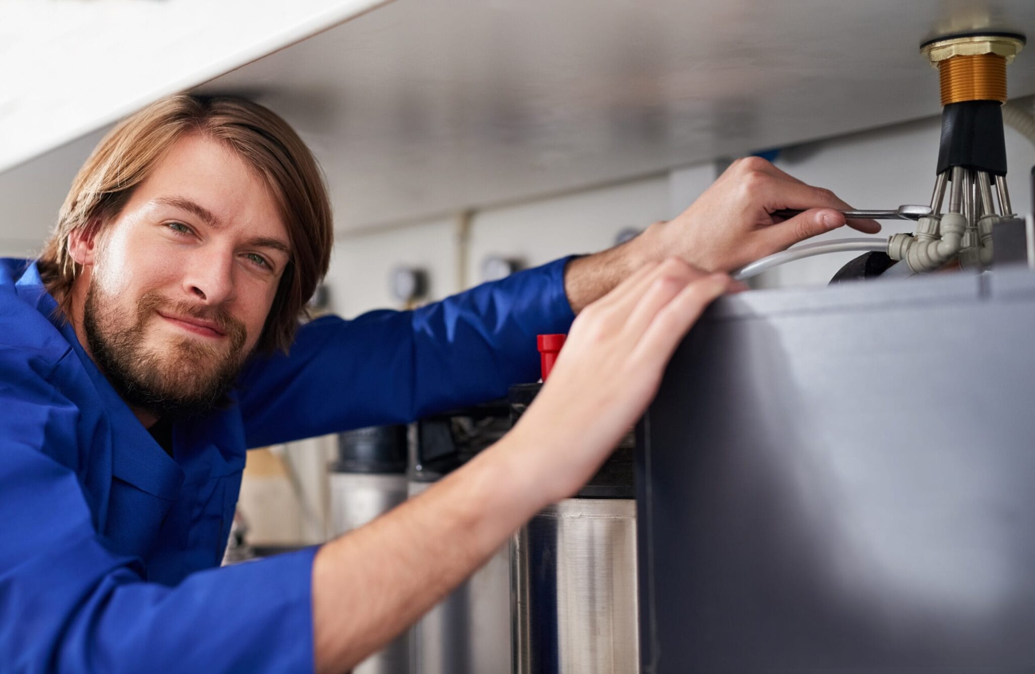 Technician servicing a residential water heater tank in Orlando