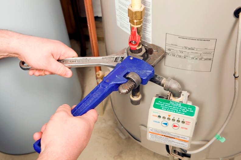 Plumber repairing a water heater valve in Orlando